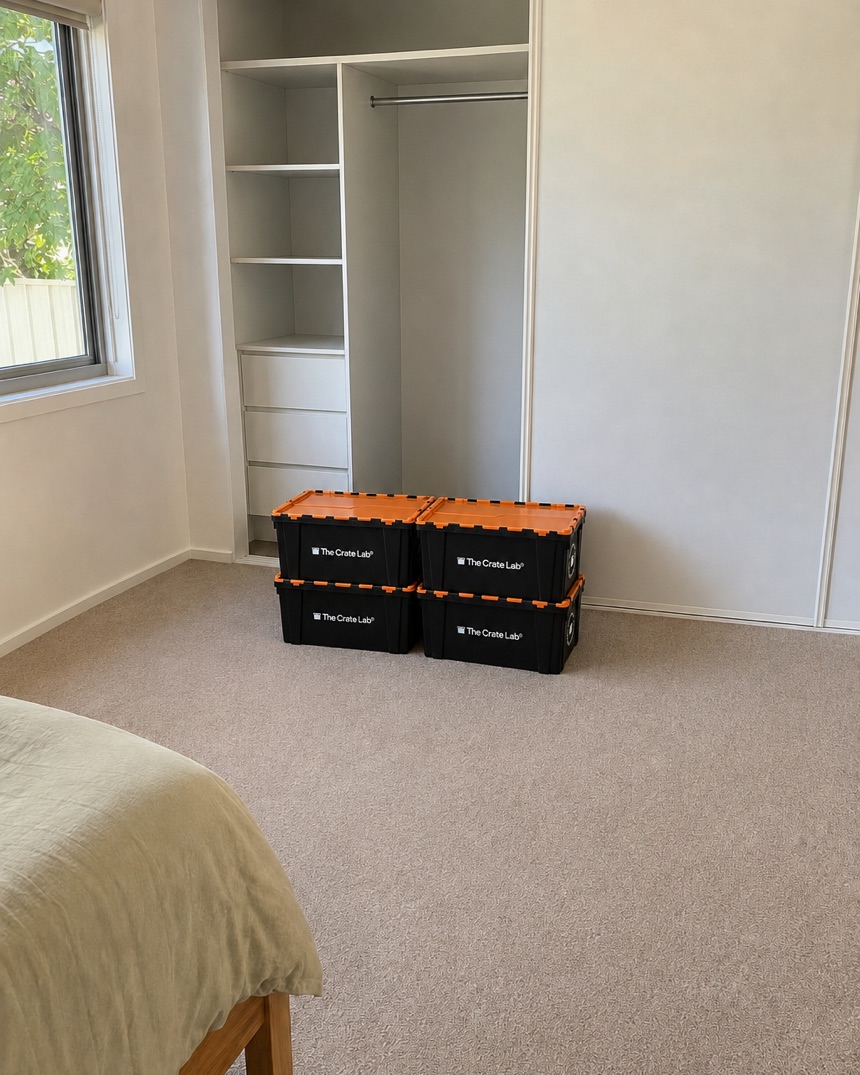 The wardrobe emptied with Crate Lab crates packed and stacked